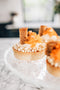 carrot cake tart made from vanilla shortcrust pastry, carrot cream filling, carrot jelly, mascarpone cream, carrot cake, walnuts, white chocolate pearls, grated carrot and cinnamon made fresh by tartlet bakery