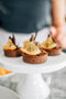 choc-orange tart made from chocolate shortcrust pastry base, orange crunch filling topped with a glossy dark chocolate ganache, garnished with dark chocolate shavings, dust of cocoa powder and a slice of candied orange made fresh by tartlet bakery